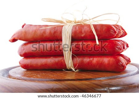smoked beef sausages served on a wooden plate