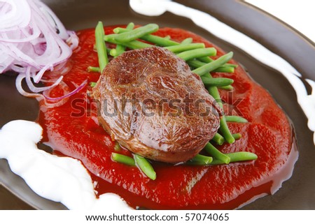 beef meat on red sauce with beans