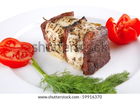 beef steak with melted yellow cheese over white