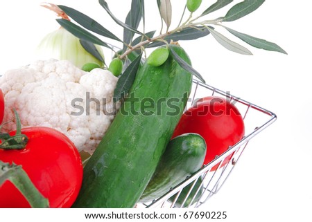 vegetables in metal store basket on white background