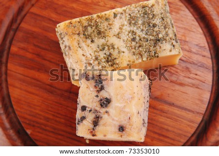 smoked cheeses on wood on white background