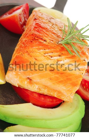 food: hot baked salmon piece served on iron pan over wooden plate isolated on white background