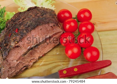 hot beef on transparent plate over wood table
