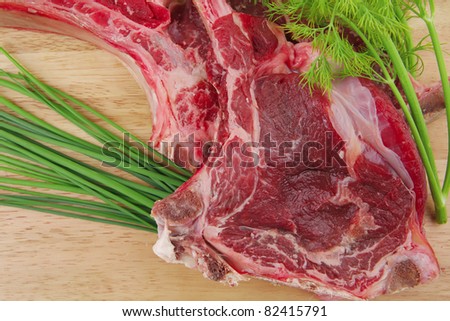 fresh raw meat : fresh red beef ribs with dill and green sprouts on wooden board isolated over white background
