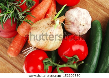 collection of raw vegetables on kitchen wooden board isolated over white background