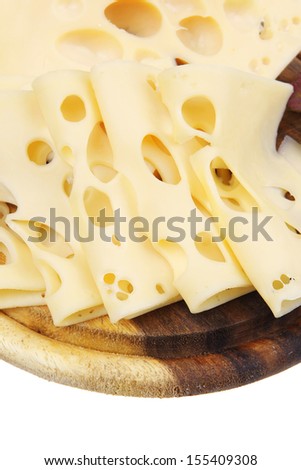 yellow edam cheese sliced on wooden platter with olives and tomato isolated over white background