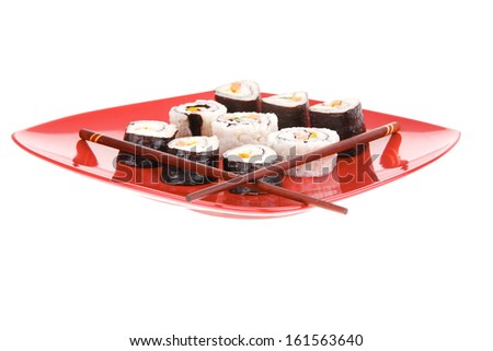 Japanese Traditional Cuisine - California Roll with Avocado and Salmon, Cream Cheese . on red dish with sticks isolated over white background
