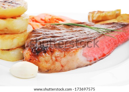 meat food : roasted fillet on white plate with tomatoes and chives isolated over white background