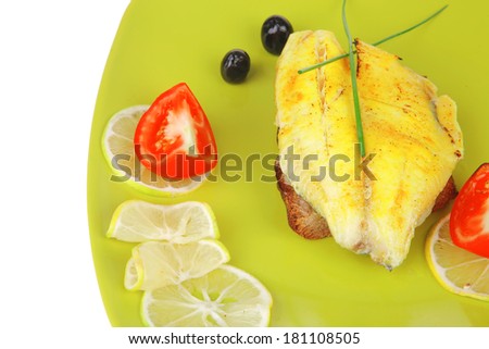 roast sea sole fish fillet served on bread with tomatoes,olives and chives on green plate isolated over white background