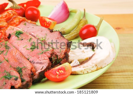 corned beef on plate over wooden table