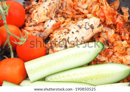 meat grilled chicken fillet cooked with vegetables on ceramic pan isolated over white background