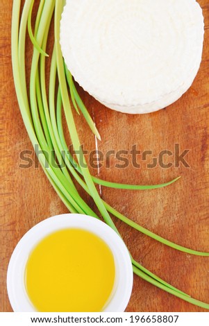 diet products : salted greek feta white cheese on wood with olive oil in saucer isolated over white background