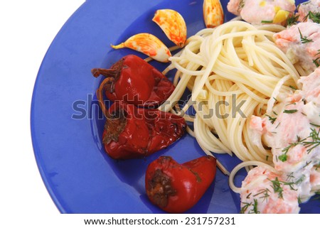 fresh rose wild salmon baked in cream cheese sauce with italian pasta and red hot pepper on blue plate isolated over white background