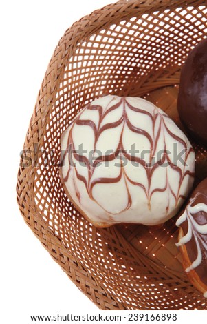 traditional jewish holiday chanuka donuts covered by dark chocolate on retro vintage basket isolated on white background