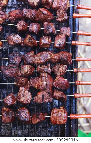 fresh raw turkey fillet steak red meat brisket on skewers barbecue brazier grid full burned charcoal