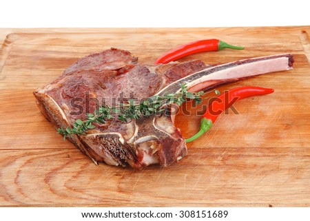 meat food : roast rib on wooden plate with thyme isolated over white background