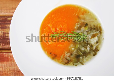 european cuisine: dual components vegetable soup served with toasts on wood