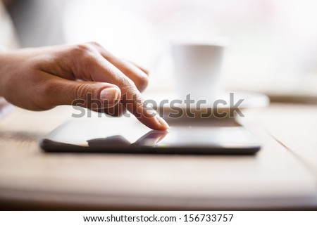 Close up of hands woman using her cell phone in restaurant,cafe