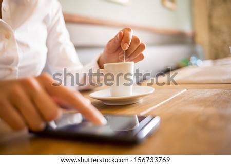 Close up of hands woman using her cell phone in restaurant,cafe