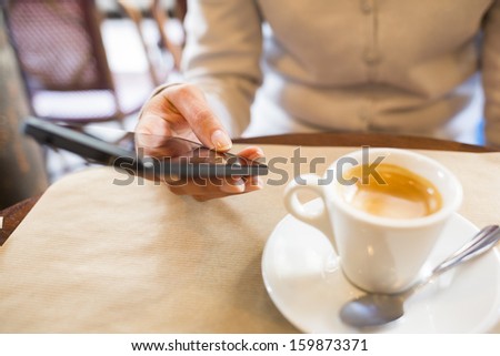 Close up of hands woman using her cell phone in restaurant,cafe, sms, mail, message
