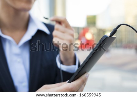 Businesswoman calling on the cell phone in working environment, Building background