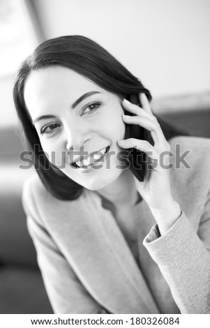 Pretty young woman on phone in coffee bar