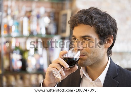Handsome man drinking a glass of red wine in bar Stockfoto © 