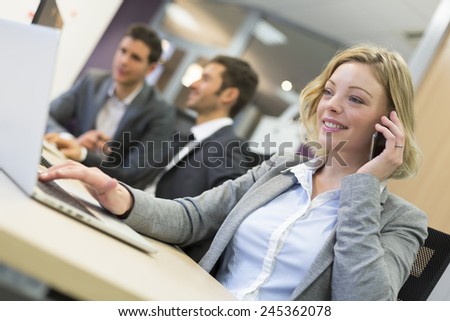 Businesswoman talking on the cell phone in modern office