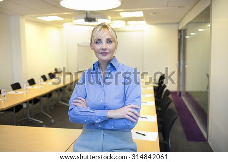 Portrait of pretty business woman in meeting room