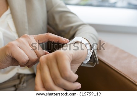 Woman using her smart watch app. Close-up hands