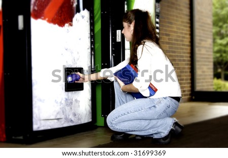 Woman getting soda from vend machine