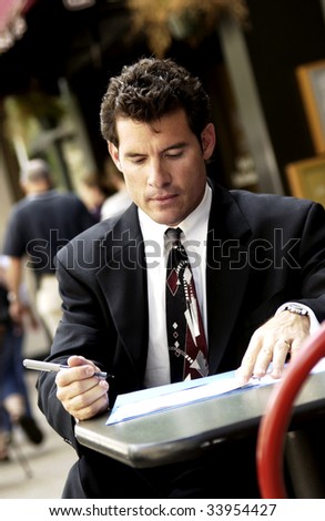 businessman talking on cell phone outside