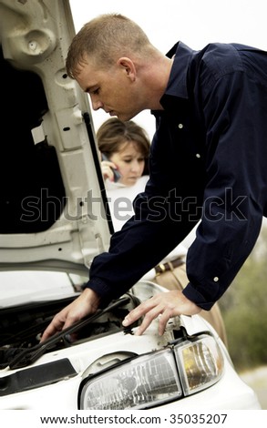 man fixing car