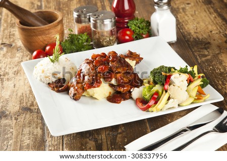 Chicken in tomato sauce with a boiled vegetables, turkish pilav ( pilaf ), thyme and sage
