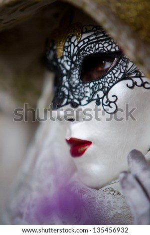 VENICE - FEB 9: An unidentified masked person in costume in St. Mark\'s Square during the Carnival of Venice on February 9, 2013. The 2013 carnival was held from January 26 Th to February 12 Th