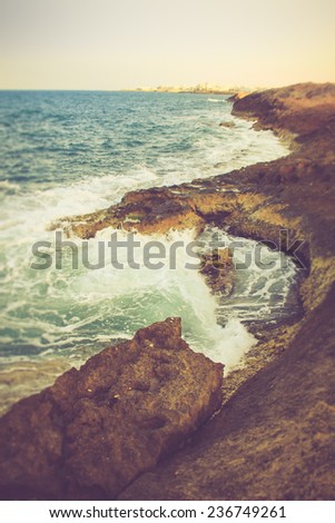Beautiful summer landscape with rocky shore by the Mediterranean Sea. Filtered image:cross processed vintage effect.