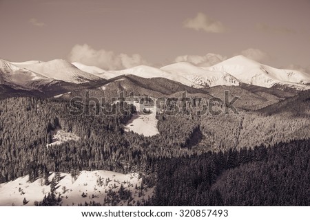 Beautiful winter landscape with snow covered mountains.Filtered image:cross processed retro effect.