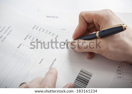 Close-up of man paying bills pen in hand