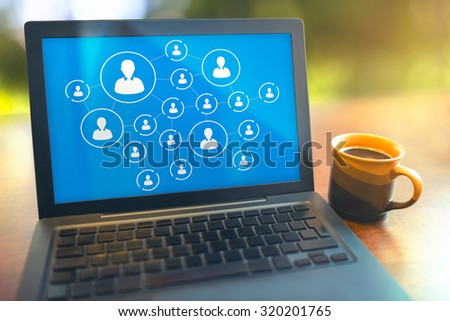 Social media connection concept laptop on table with a coffee cup