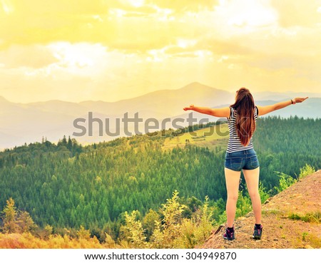 Free happy woman enjoying nature in the mountains. Outdoor.