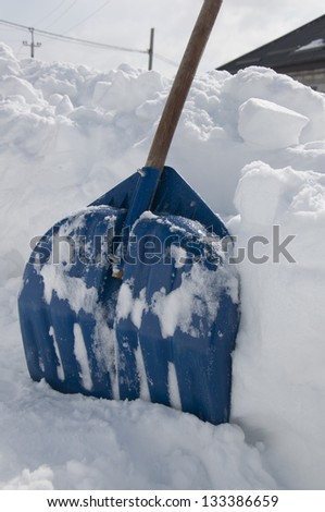 Similar – Image, Stock Photo Shoving snow on the roof. Remove snow from solar system