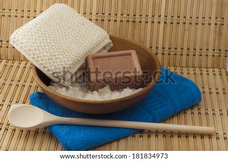 soap, sea salt in a wooden bowl cleansers on the background of bamboo