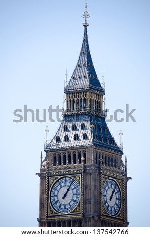 Big Ben showing two clock-faces and a beautiful blue sky.