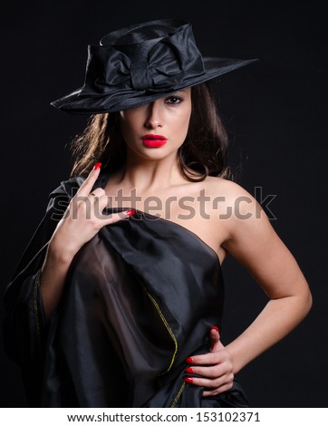 Beautiful woman wearing a stylish hat and a sheer dress