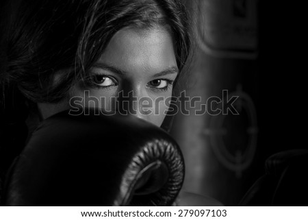 boxing girl with black gloves and long hair, with beautiful eyes. black and white