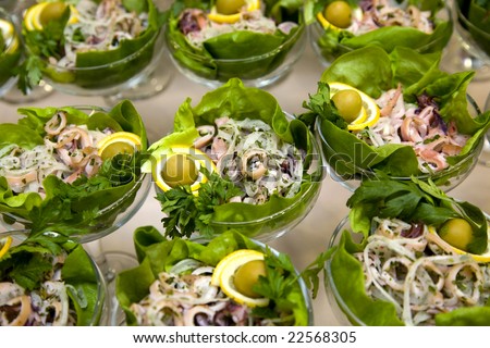 Fresh vegetarian salad with fish serve in glass