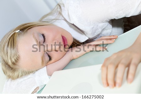 Young Beautiful Businesswoman sleeping at work desk