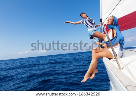 Happy women on the bow of a Sailboat.Copy space