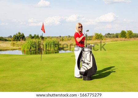 Portrait of female golfer taking a stick