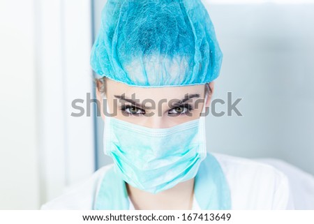 Portrait of a beautiful female doctor wearing protective work wear,head shot